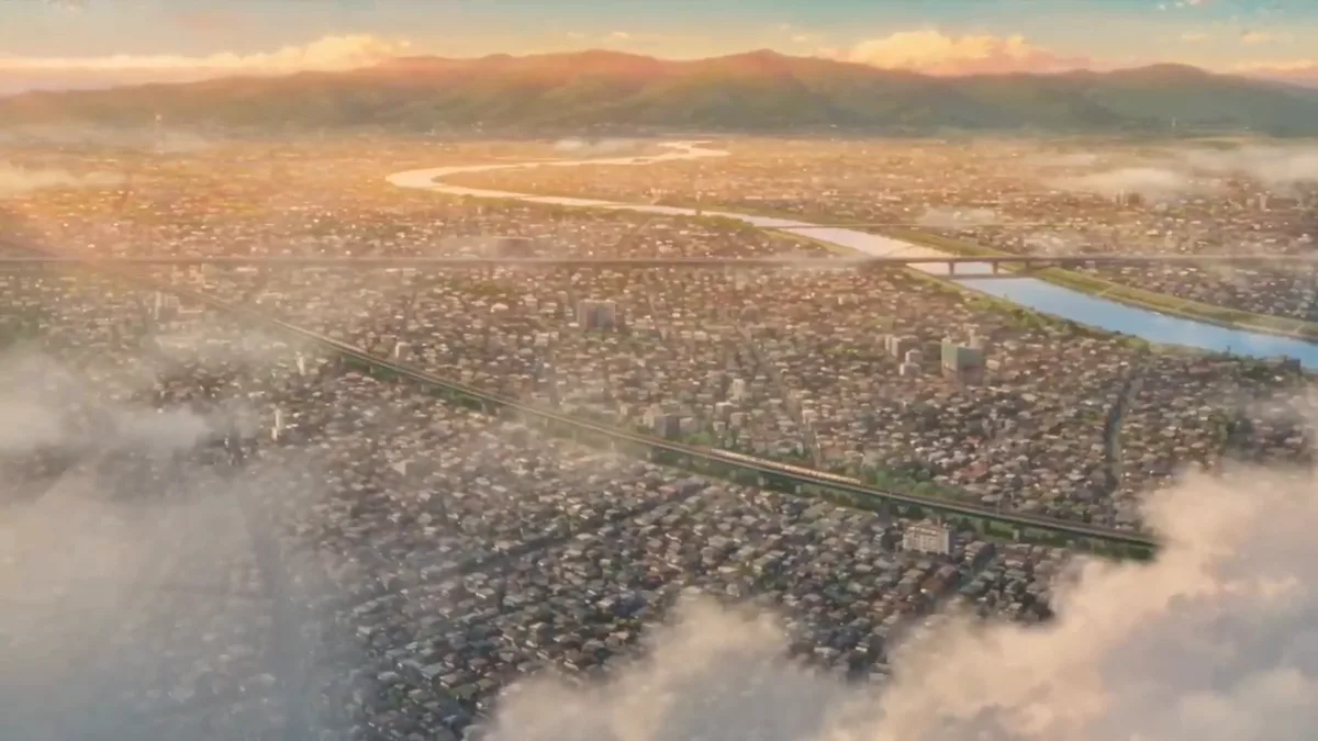 A wide valley town seen from above, under morning mist